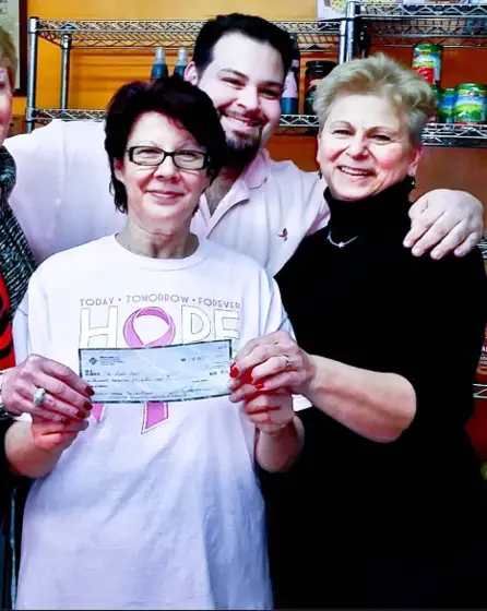 Rosa presenting the $1,200 check to the Pink Ladies