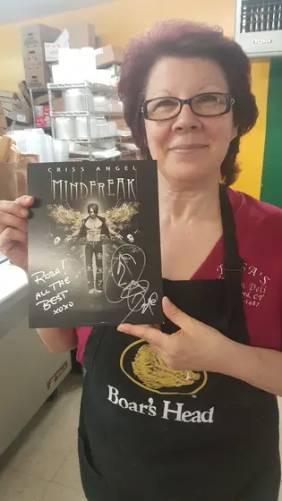 Rosa holding a signed Criss Angel Mindfreak photo