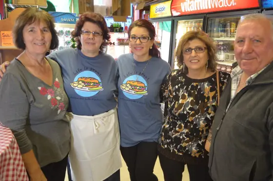 The Rosa's team in the deli, three of them in matching Rosa's T-shirts
